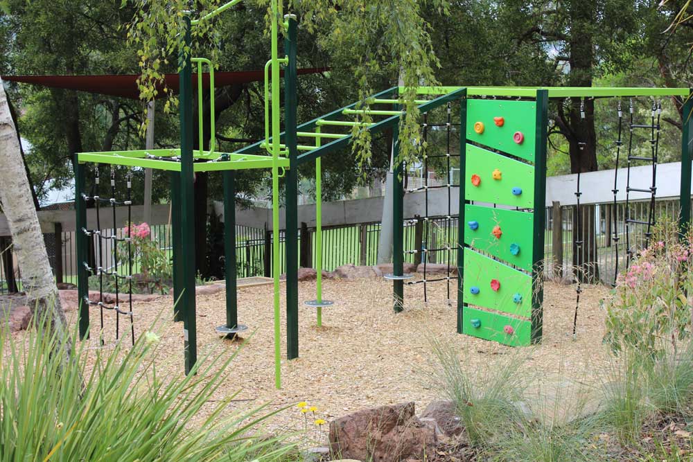 Northcote Climbing Cube at Cire Community School Yarra Junction, featuring rope nets, climbing panels and overhead bars in a natural bushland setting.
