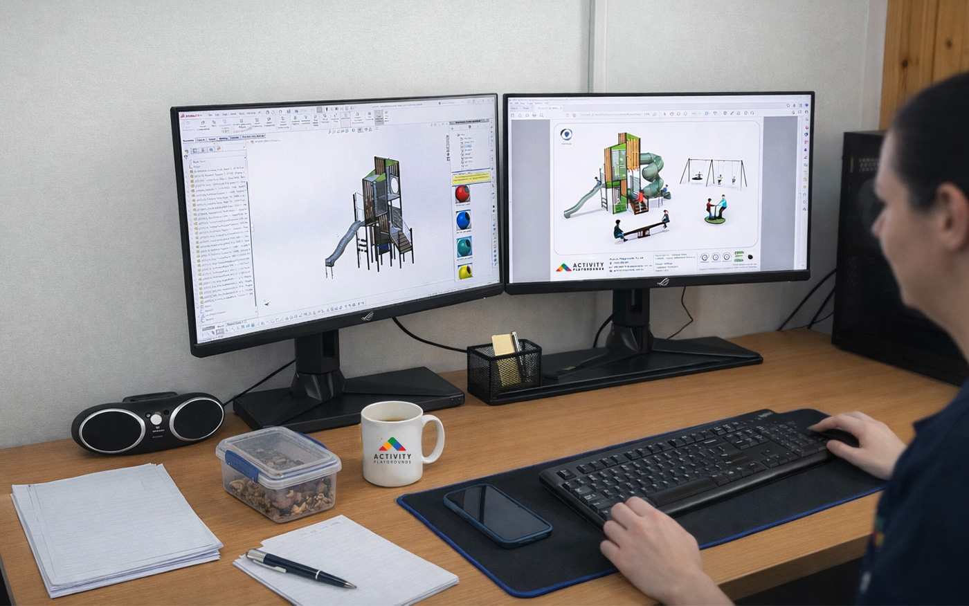 Graphic banner showing colourful playground design concept sketches and layout plans on desk, promoting custom playground design services