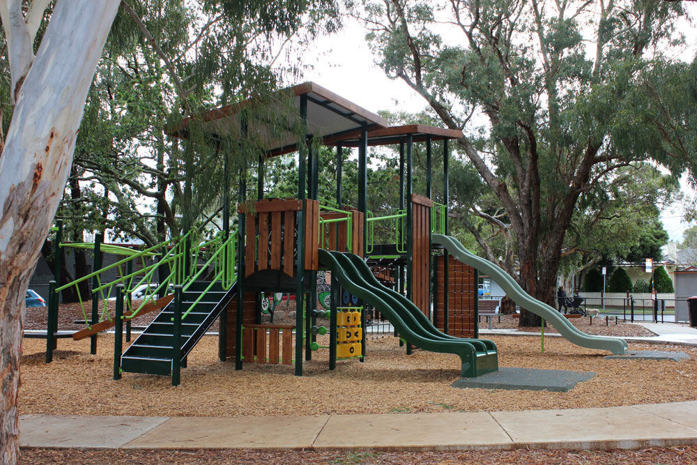 Multi-level Fortitude playground structure with slides, climbing and rope elements at Lipscombe Park
