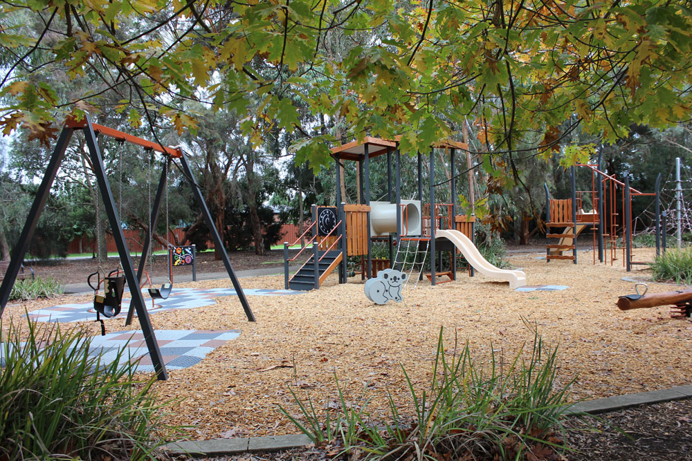 playground framed by native plants showing Fortitude unit, agility trail and surrounding trees