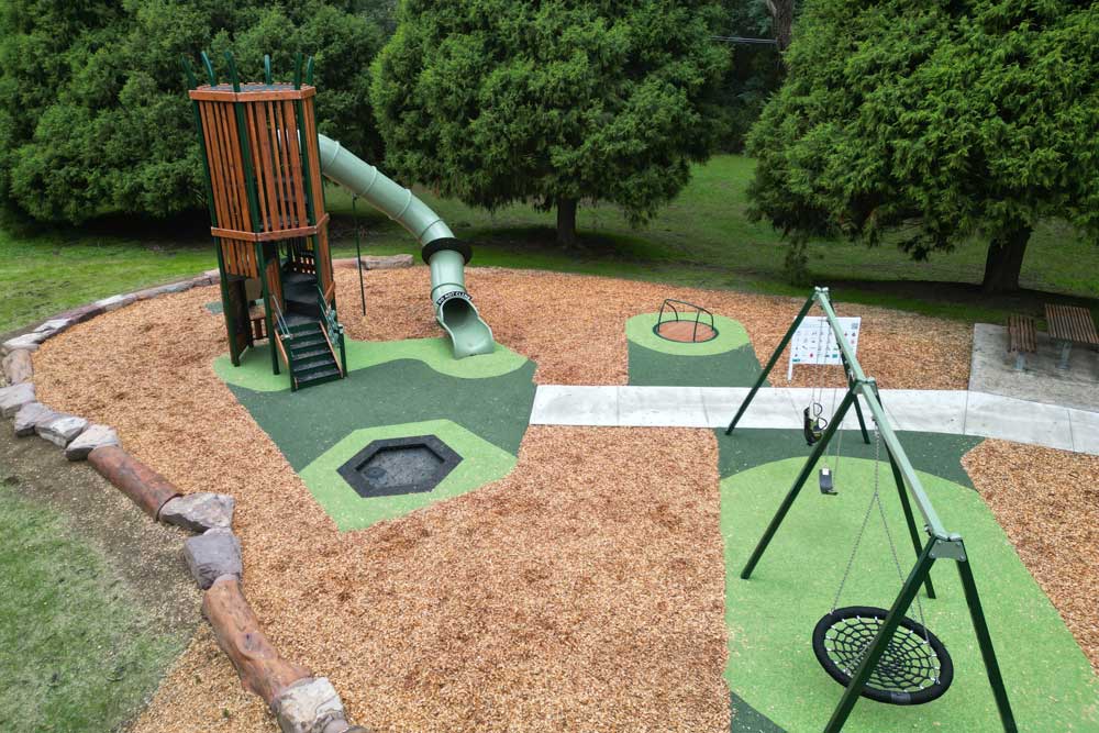 Wedge Tail Nest tower at Mount Evelyn Recreation Reserve featuring a tall timber structure, enclosed tube slide and climbing wall surrounded by native bushland.