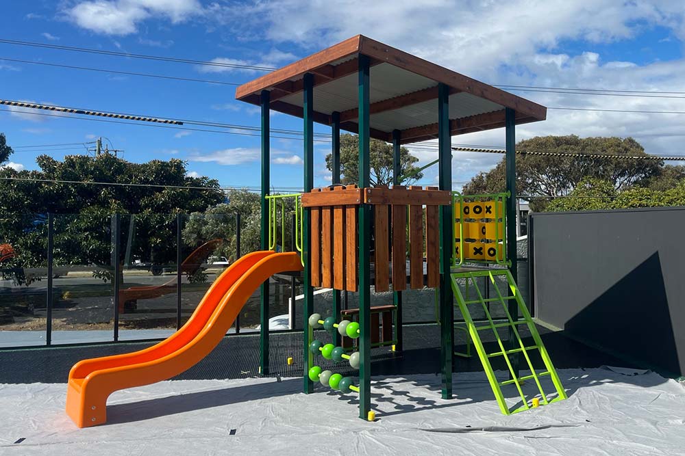 Early learning playground in Frankston with timber play structure, slide, climbing frame and activity panels